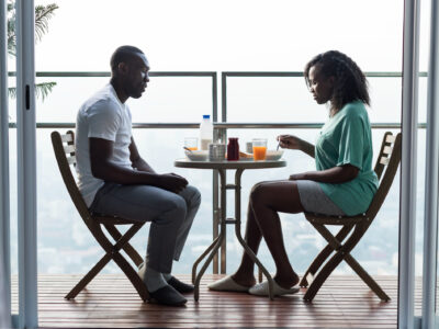 couple-having-breakfast-together-balcony
